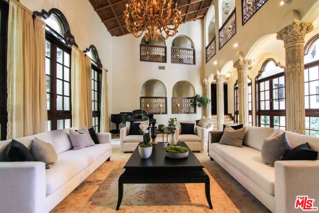 1016 Moraga Drive Los Angeles, CA 90049 - Photo 5 of 30 a living room with furniture fireplace and a large window