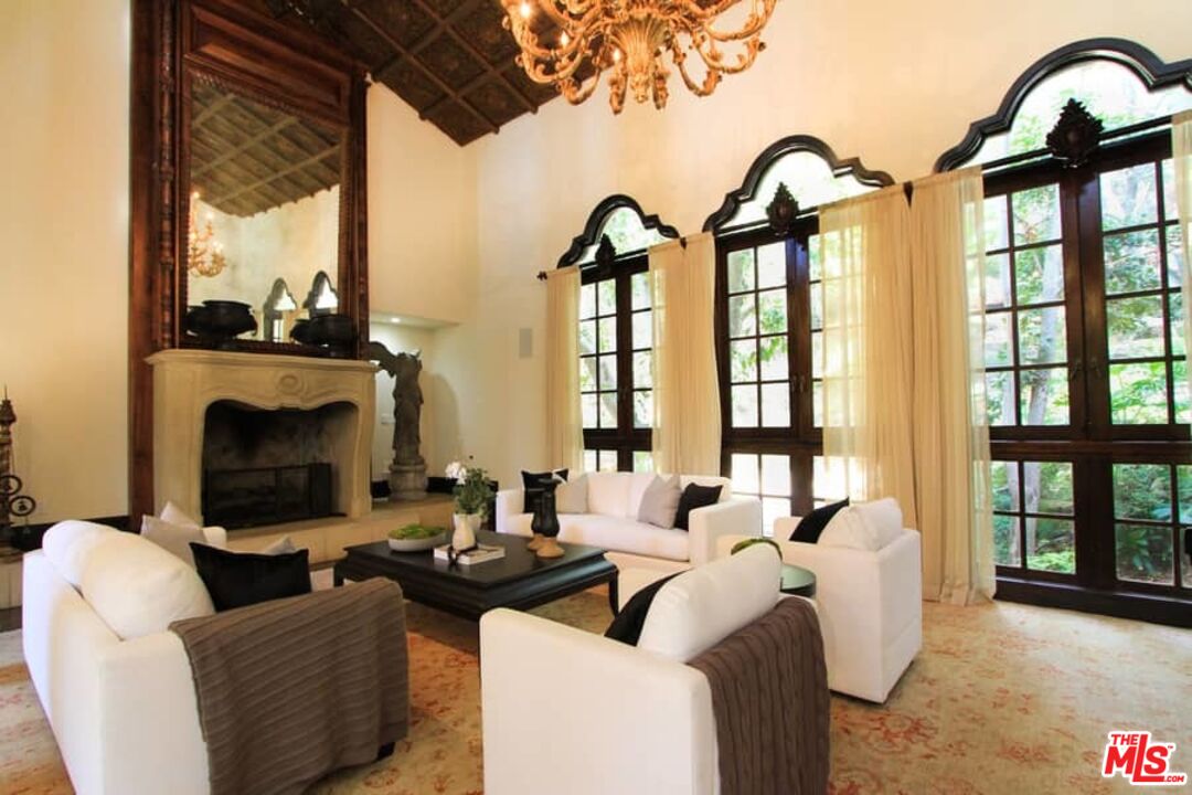 1016 Moraga Drive Los Angeles, CA 90049 - Photo 7 of 30 a living room with fireplace furniture and a large window