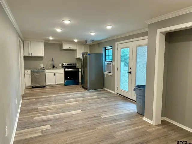 a view of a kitchen with a sink and a refrigerator