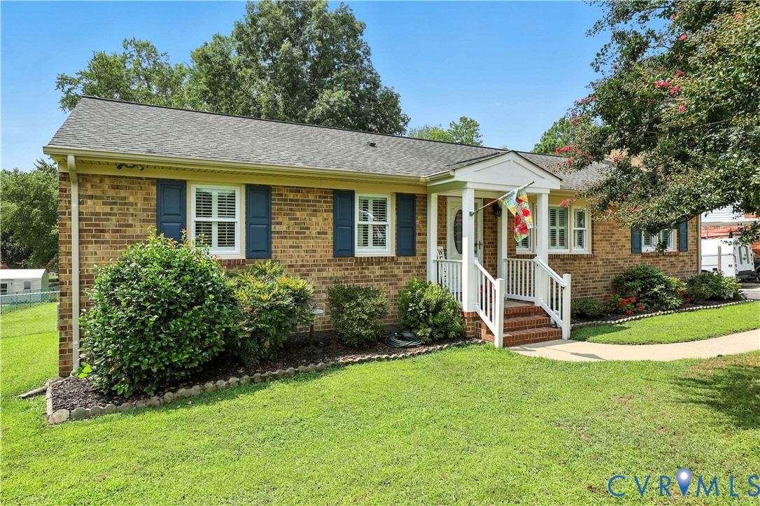 11407 Delgado Road Midlothian, VA 23112 - Photo 3 of 35 a view of a white house with a big yard and potted plants