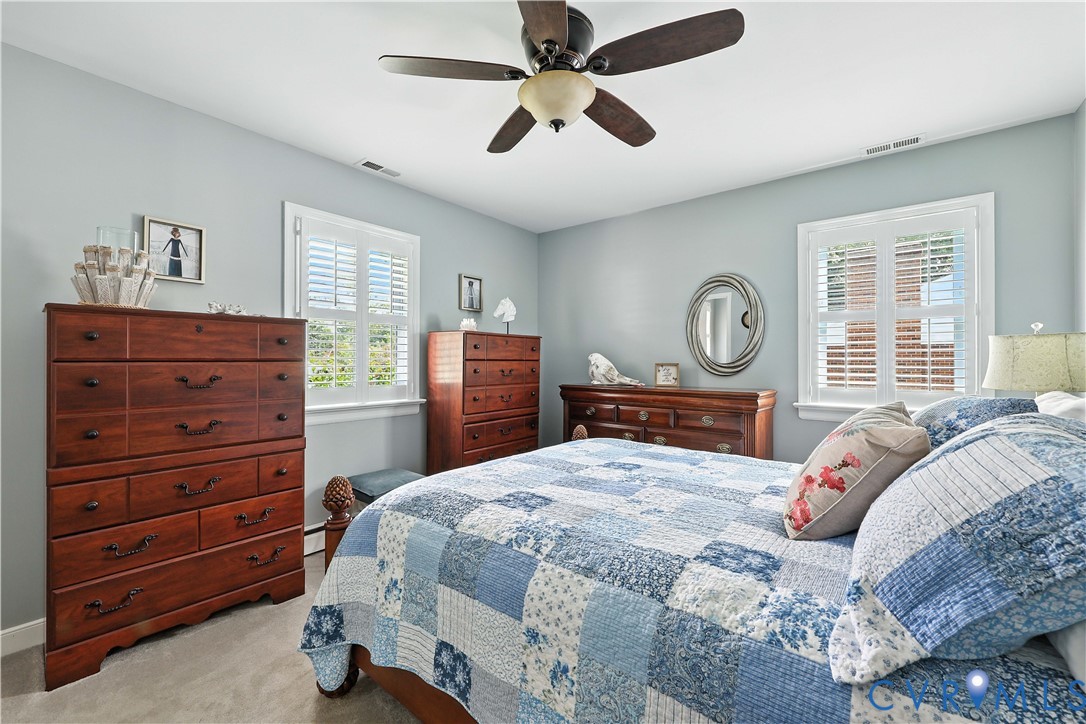 11407 Delgado Road Midlothian, VA 23112 - Photo 8 of 35 a bedroom with a bed and a chandelier