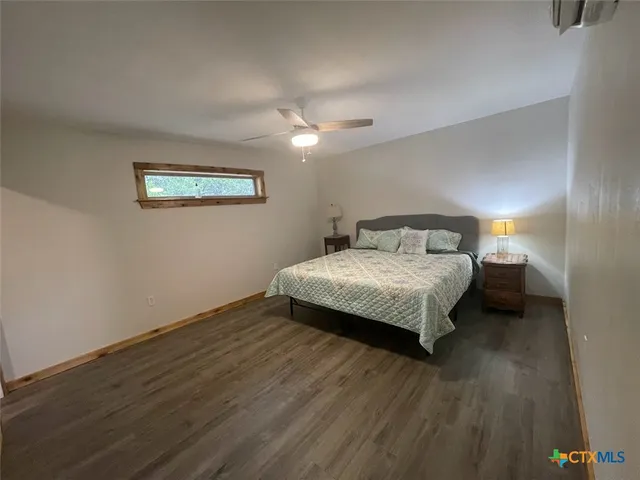 a bedroom with a bed and a night stand