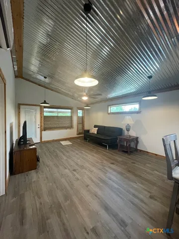 a view of a livingroom with furniture nad wooden floor
