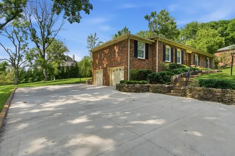 a front view of a house with a garden