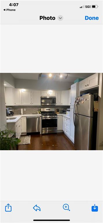 1444 74th Street Brooklyn, NY 11228 - Photo 2 of 7 a kitchen with a refrigerator and a stove
