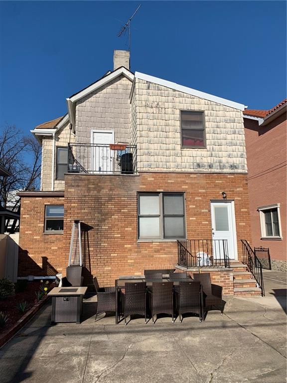 1444 74th Street Brooklyn, NY 11228 - Photo 4 of 7 a front view of a house with a yard