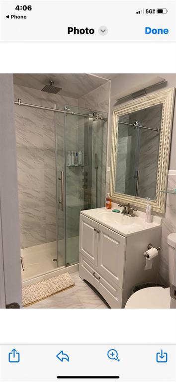 1444 74th Street Brooklyn, NY 11228 - Photo 6 of 7 a bathroom with a tub sink mirror and shower