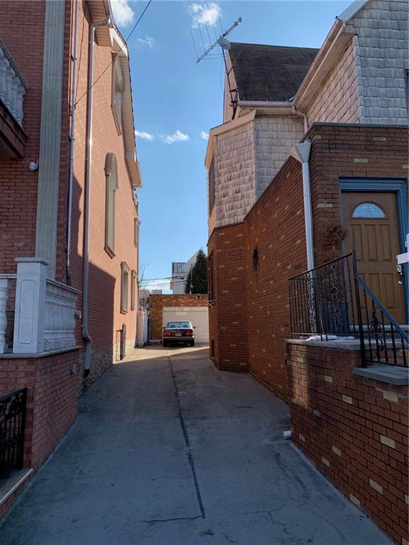1444 74th Street Brooklyn, NY 11228 - Photo 7 of 7 a view of a house with a barbeque and wooden stairs