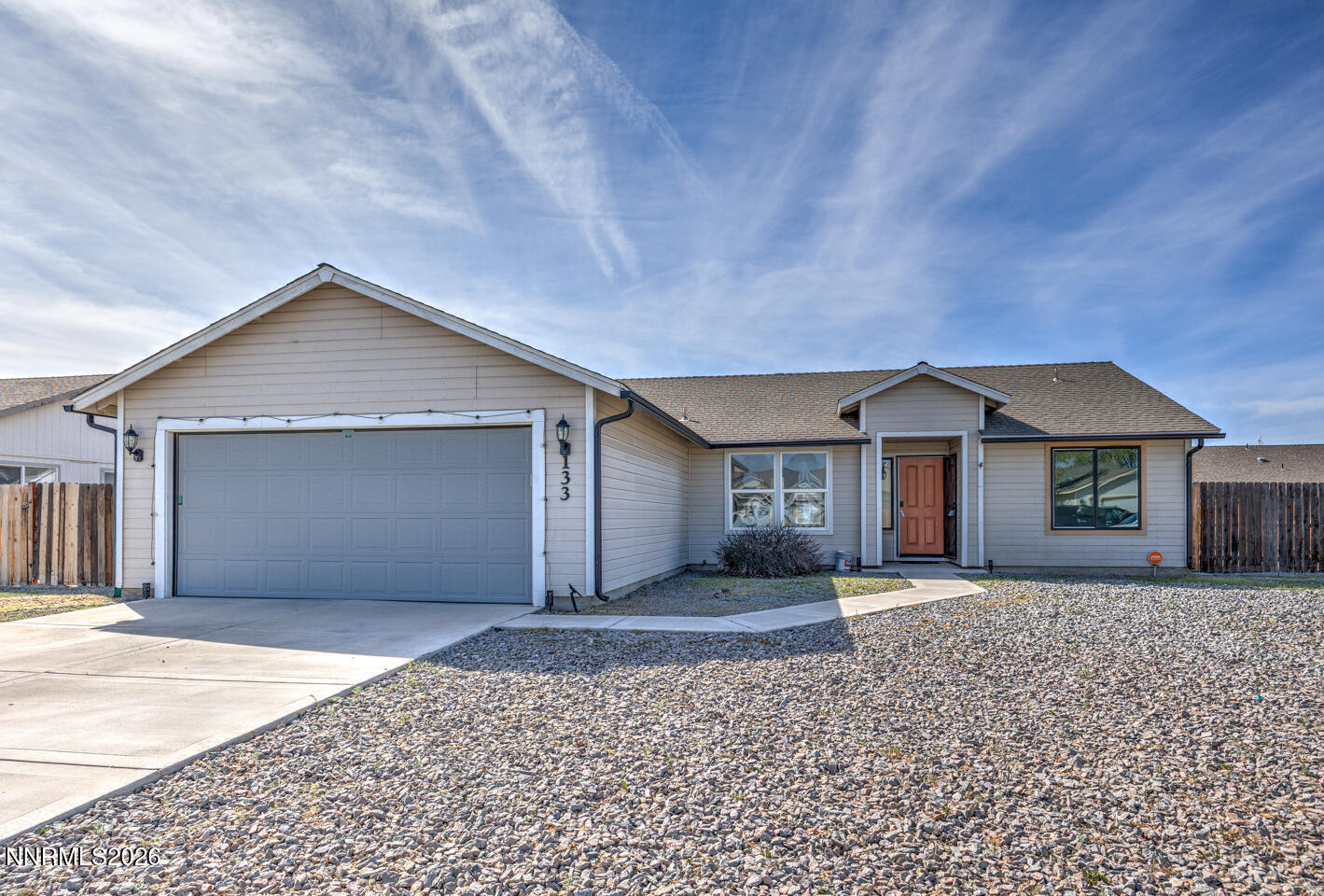133 Prairie Lane Fernley, NV 89408 - Photo 1 of 22 a front view of a house with a yard and garage