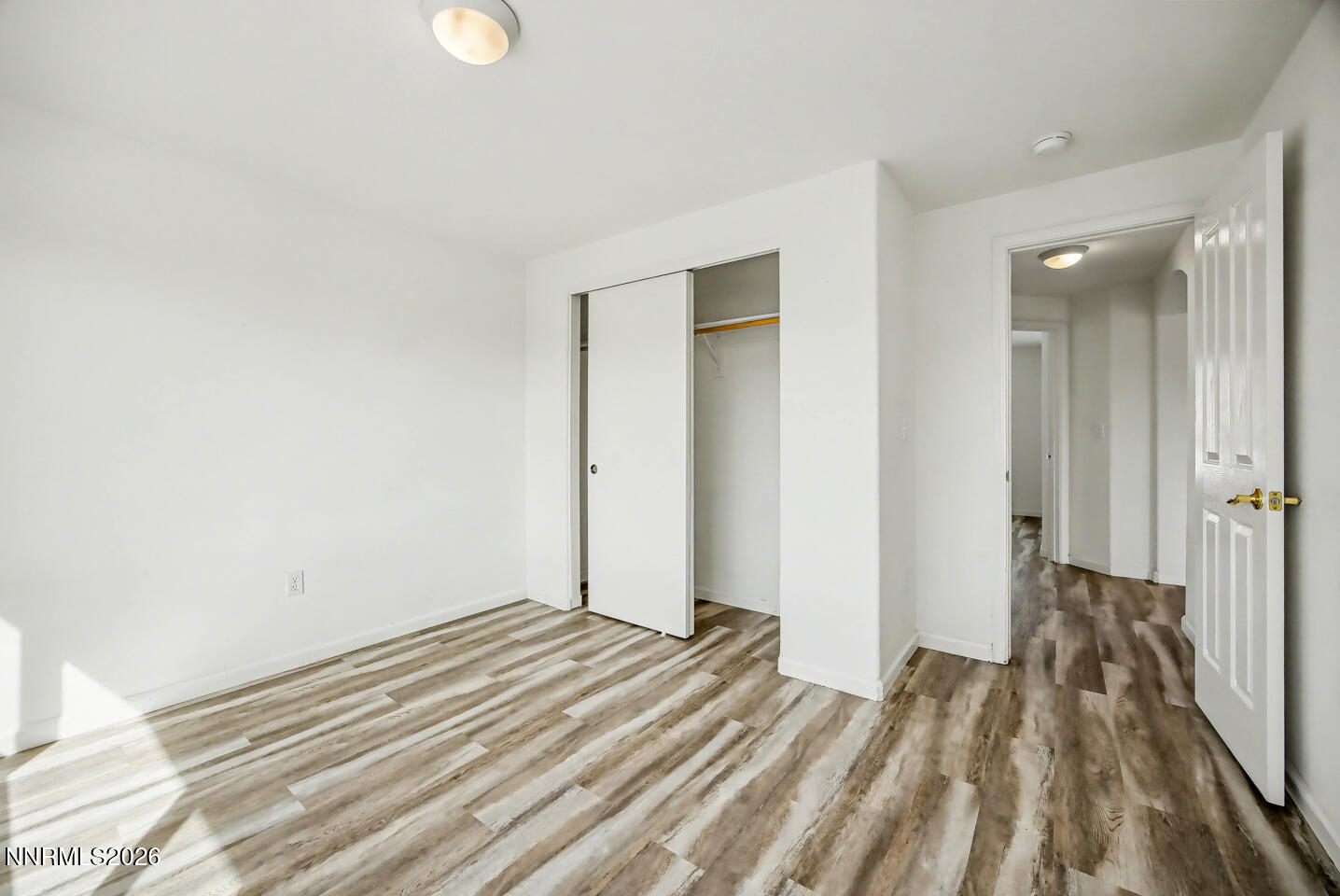 133 Prairie Lane Fernley, NV 89408 - Photo 11 of 22 a view of a room with wooden floor and bathroom