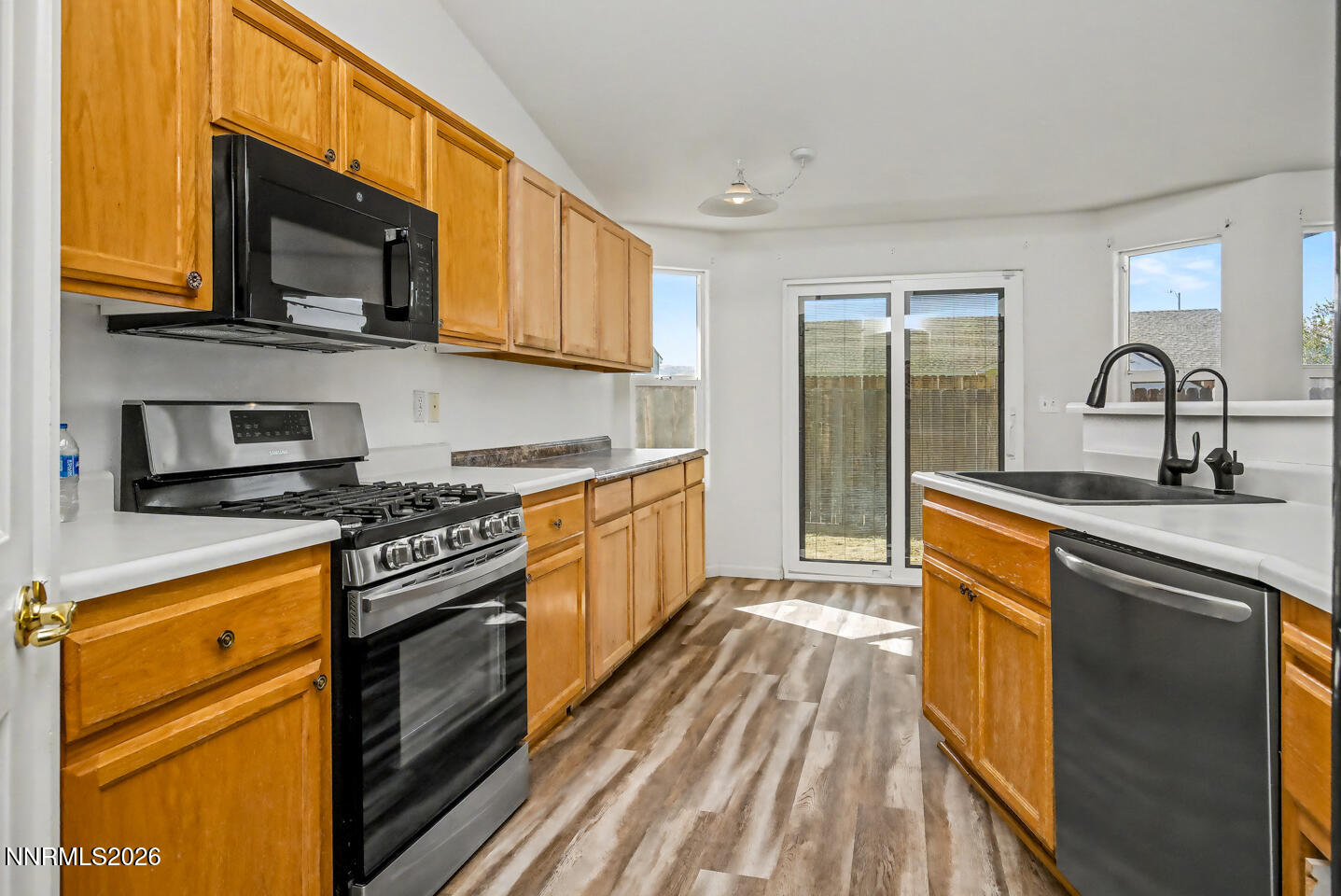 133 Prairie Lane Fernley, NV 89408 - Photo 4 of 22 a kitchen with stainless steel appliances granite countertop a stove a sink and a microwave