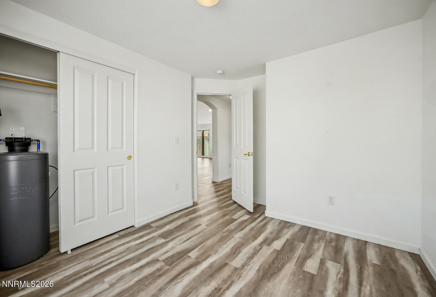 133 Prairie Lane Fernley, NV 89408 - Photo 8 of 22 a view of a livingroom with wooden floor and closet