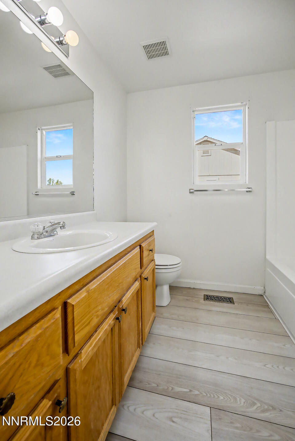 133 Prairie Lane Fernley, NV 89408 - Photo 9 of 22 a bathroom with a sink a toilet and mirror