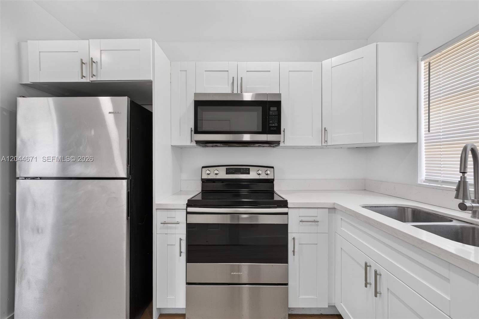 1900 Southwest 6th Street, Unit 6 Miami, FL 33135 - Photo 5 of 20 a kitchen with a refrigerator stove and microwave