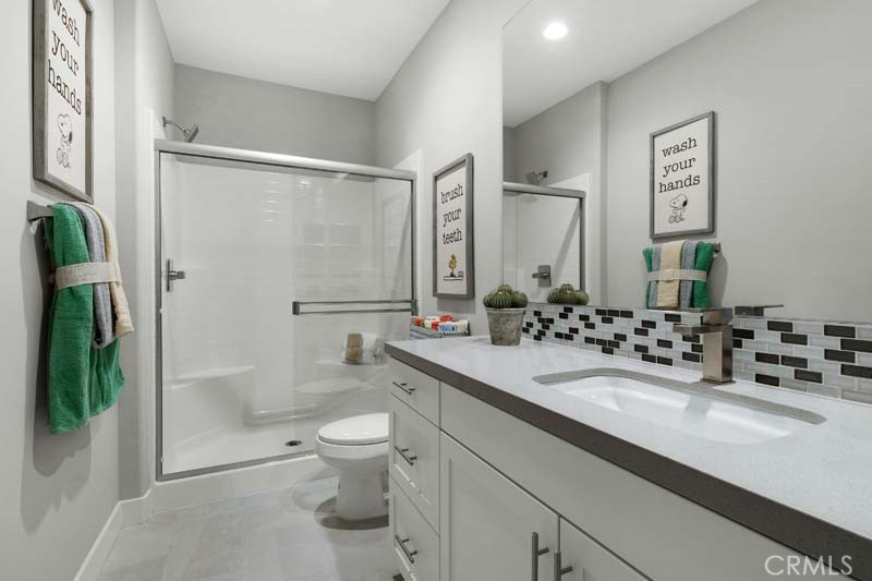 38924 Malva Rosa Drive Palmdale, CA 93551 - Photo 17 of 25 a bathroom with a double vanity sink toilet and shower