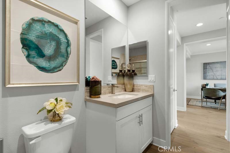 38924 Malva Rosa Drive Palmdale, CA 93551 - Photo 22 of 25 a bathroom with a sink a toilet and a mirror