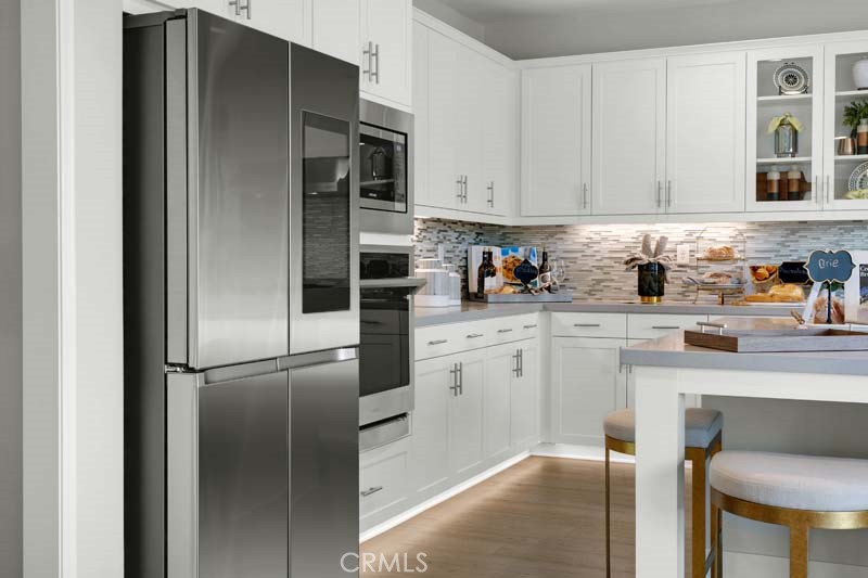 38924 Malva Rosa Drive Palmdale, CA 93551 - Photo 10 of 25 a kitchen with stainless steel appliances granite countertop a refrigerator and a stove top oven