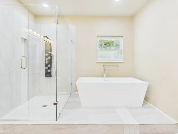 a white bath tub sitting next to a white sink