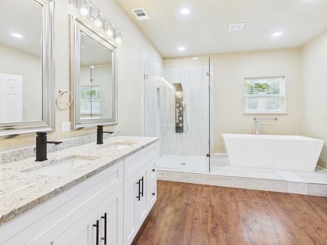 910 Cream Level Road Athens, TX 75751 - Photo 12 of 40 a bathroom with a granite countertop sink mirror and bathtub