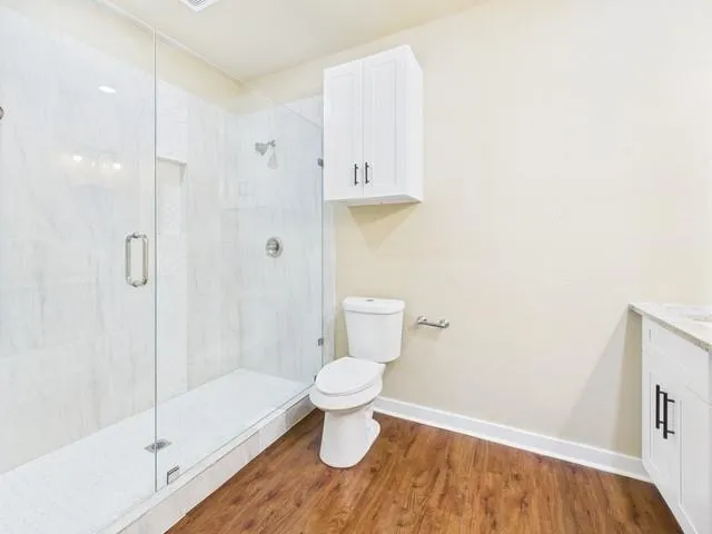 a bathroom with a toilet and a shower