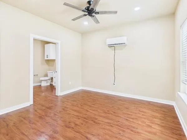 a bathroom with a granite countertop toilet sink and mirror