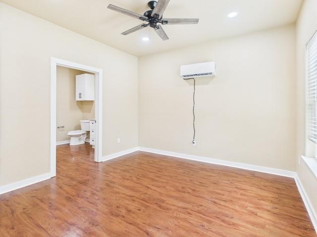 910 Cream Level Road Athens, TX 75751 - Photo 28 of 40 a view of an empty room with wooden floor and a ceiling fan