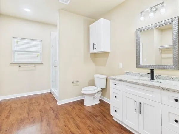 a bathroom with a sink mirror and a bathtub