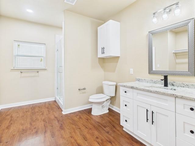 910 Cream Level Road Athens, TX 75751 - Photo 29 of 40 a bathroom with a granite countertop toilet sink and mirror
