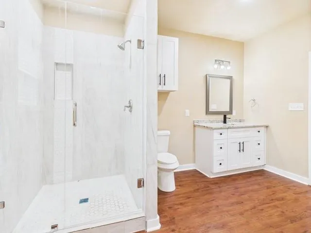 a view of empty room with wooden floor
