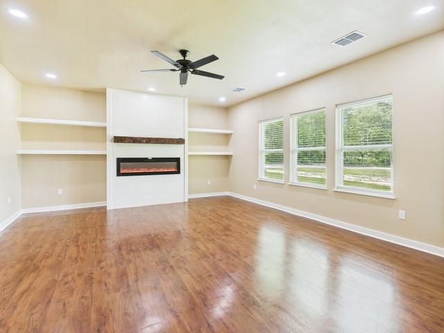 910 Cream Level Road Athens, TX 75751 - Photo 4 of 40 a view of an empty room with a window and kitchen view