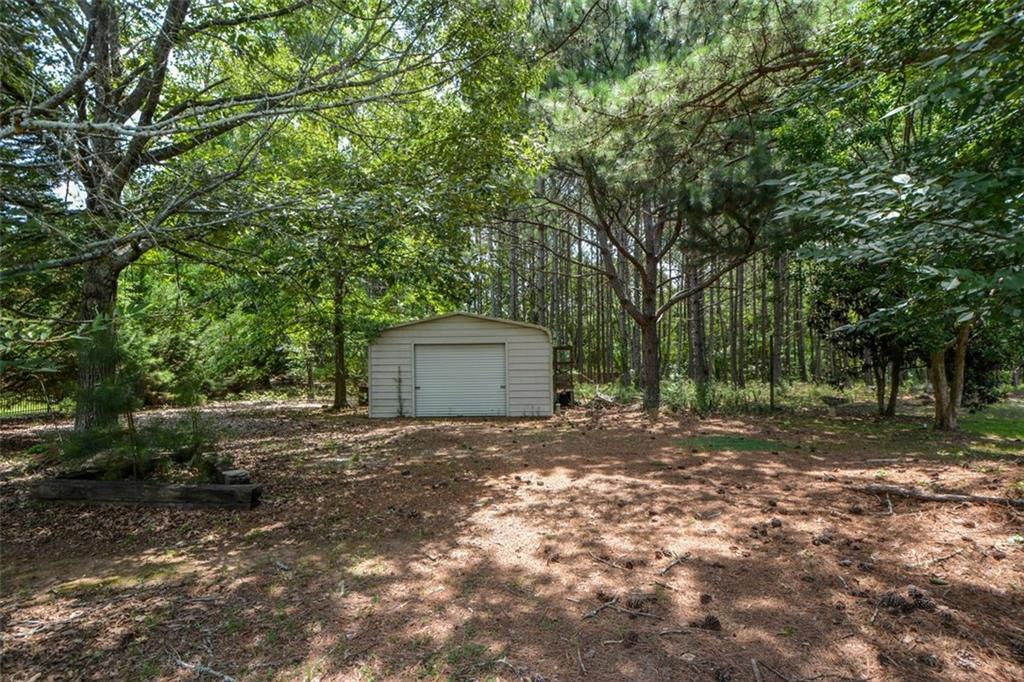 3420 Bulloch Lake Road Loganville, GA 30052 - Photo 56 of 57 a view of a yard with large trees