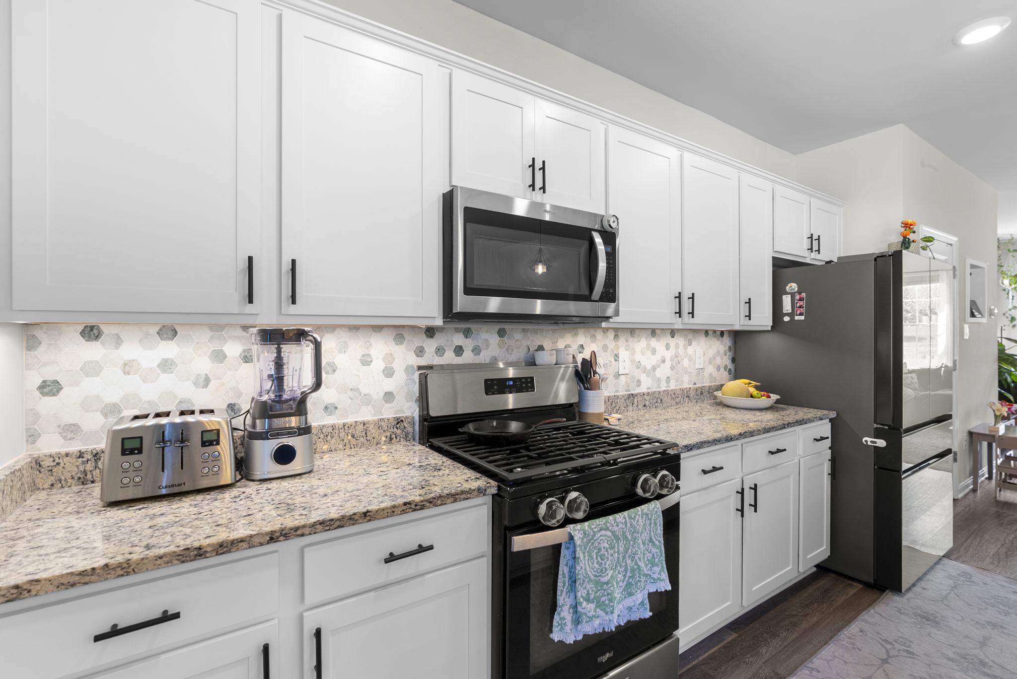 8656 Walter Martz Road Frederick, MD 21702 - Photo 14 of 30 a kitchen with granite countertop white cabinets and stainless steel appliances