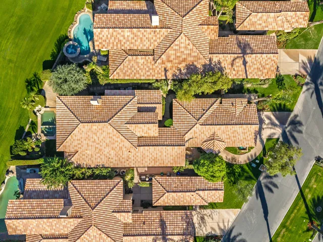 an aerial view of a house with garden space and street view