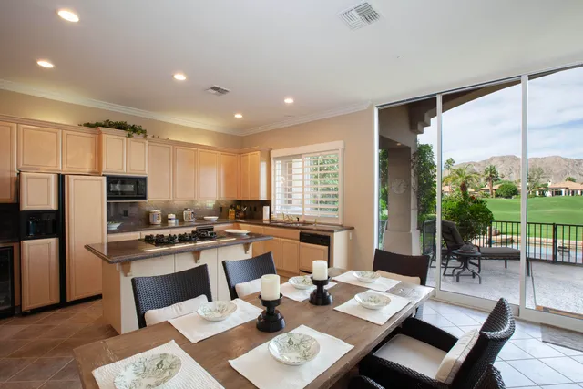 a view of a dining room with furniture a rug and wooden floor