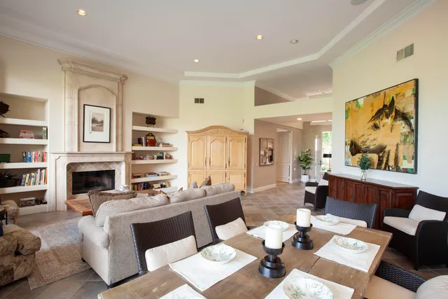 a living room with furniture a fireplace and a painting on the wall