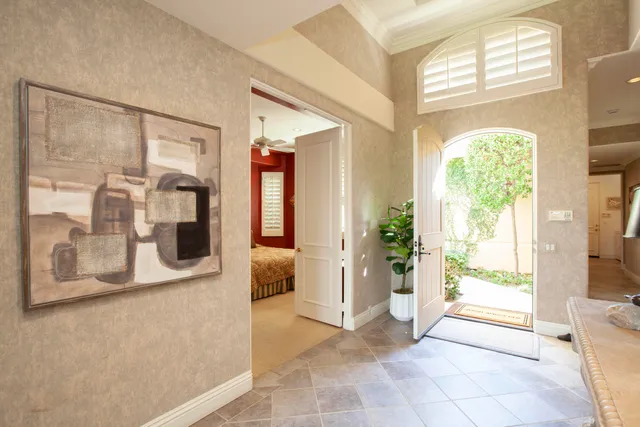 a view of an entryway with wooden floor and a livingroom