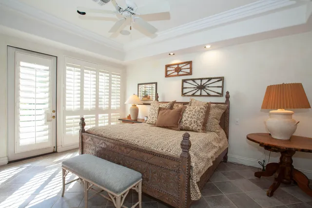 a bedroom with a bed chair and a window