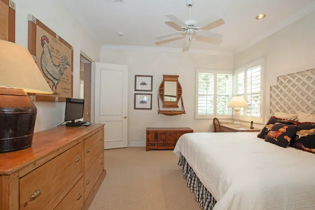 a bedroom with a bed and dresser with mirror