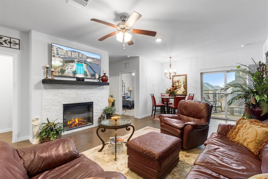 651 Watters Road, Unit 5205 Allen, TX 75013 - Photo 8 of 31 a living room with furniture a fireplace and a flat screen tv