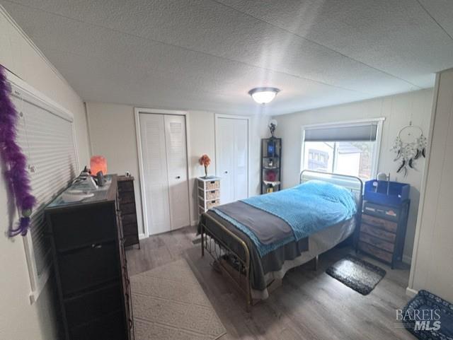 139 Coronado Circle Santa Rosa, CA 95409 - Photo 16 of 23 a spacious bedroom with a bed and wooden floor