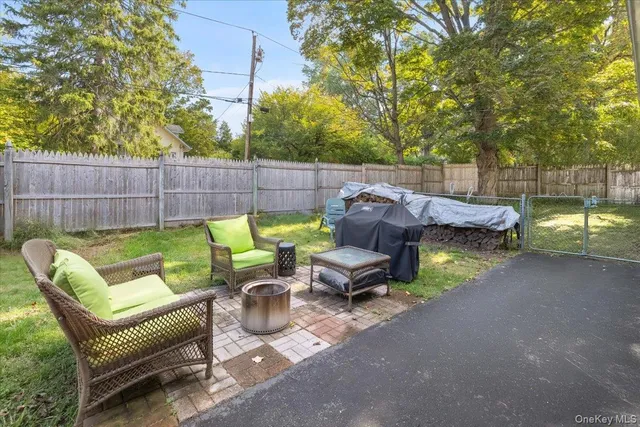 a view of backyard with outdoor seating and trees