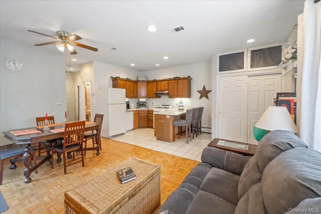 a living room with lots of furniture and kitchen view