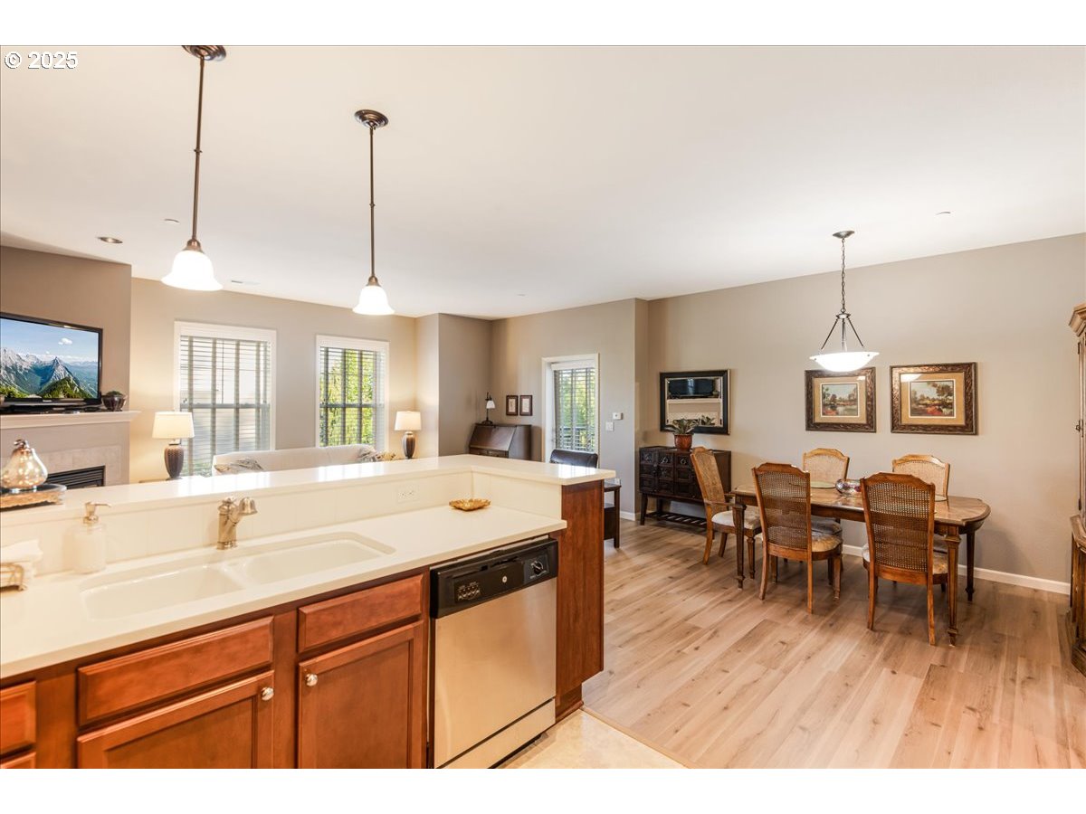 1258 Northwest Shattuck Way, Unit 309 Gresham, OR 97030 - Photo 11 of 33 a living room with stainless steel appliances granite countertop furniture a fireplace a flat screen tv and a window