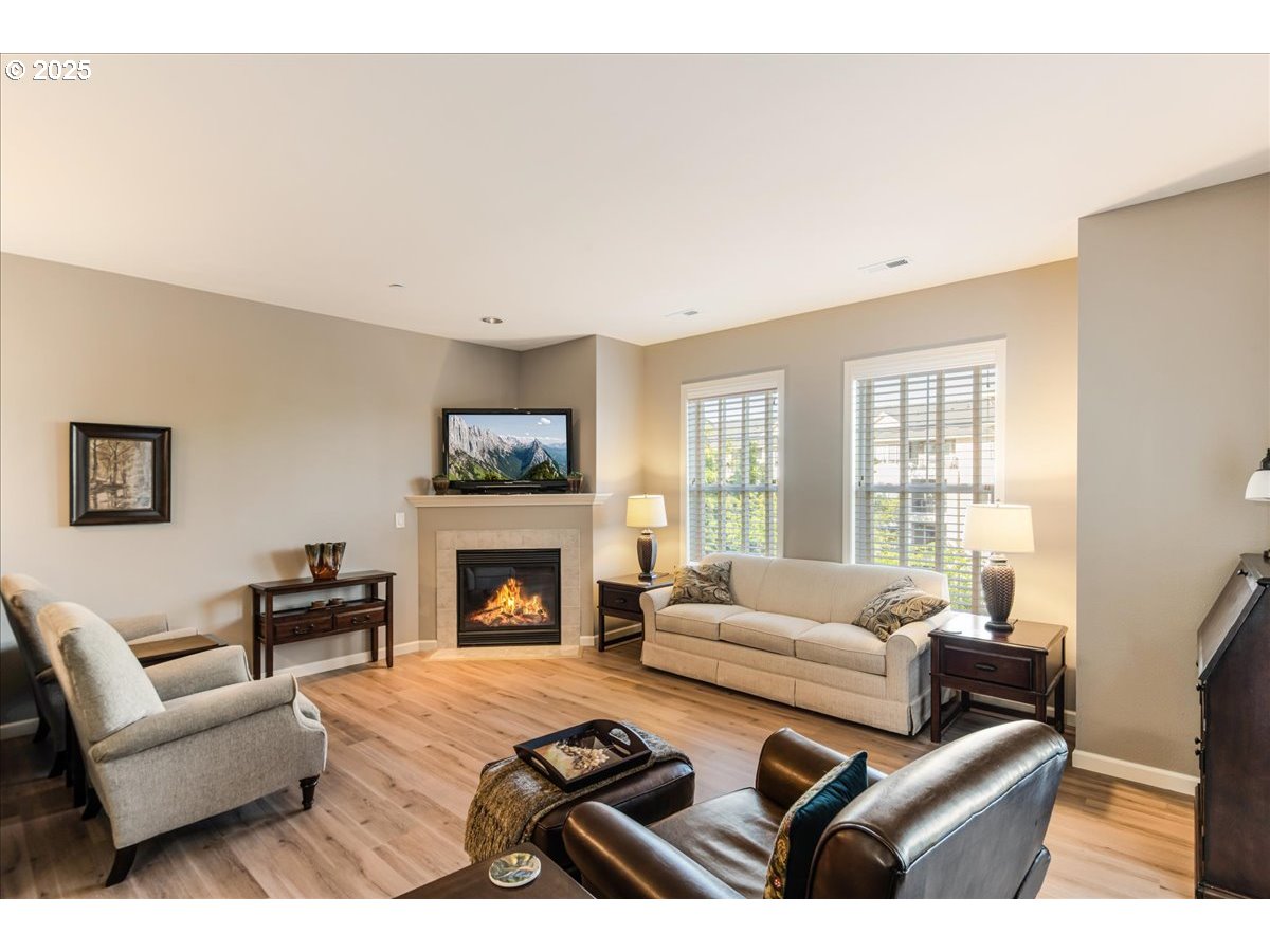 1258 Northwest Shattuck Way, Unit 309 Gresham, OR 97030 - Photo 16 of 33 a living room with furniture fireplace and a large window