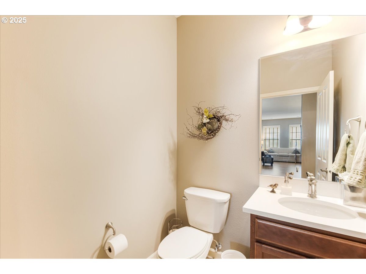 1258 Northwest Shattuck Way, Unit 309 Gresham, OR 97030 - Photo 19 of 33 a bathroom with a sink mirror and toilet