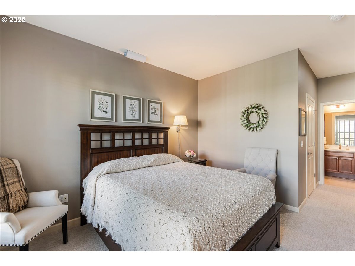 1258 Northwest Shattuck Way, Unit 309 Gresham, OR 97030 - Photo 22 of 33 a bedroom with a bed and a couch