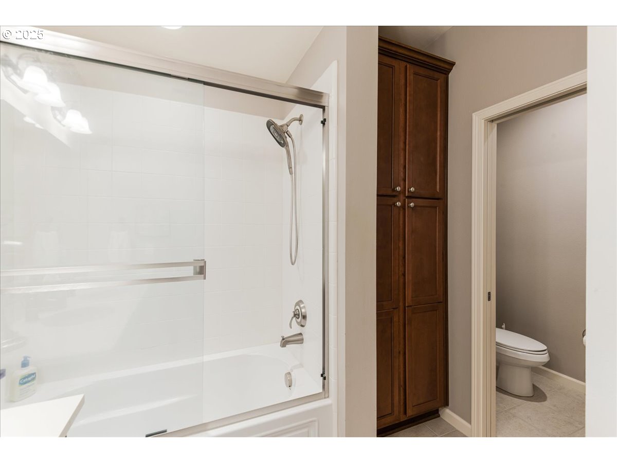 1258 Northwest Shattuck Way, Unit 309 Gresham, OR 97030 - Photo 28 of 33 a bathroom with a shower and a toilet