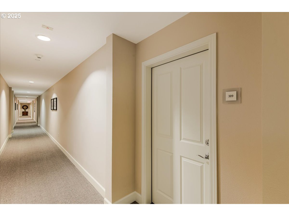 1258 Northwest Shattuck Way, Unit 309 Gresham, OR 97030 - Photo 5 of 33 a view of a hallway with wooden floor