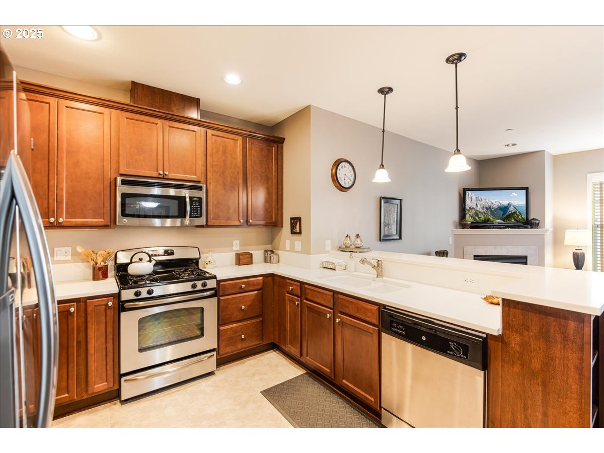 1258 Northwest Shattuck Way, Unit 309 Gresham, OR 97030 - Photo 8 of 33 a kitchen with a sink stove and microwave