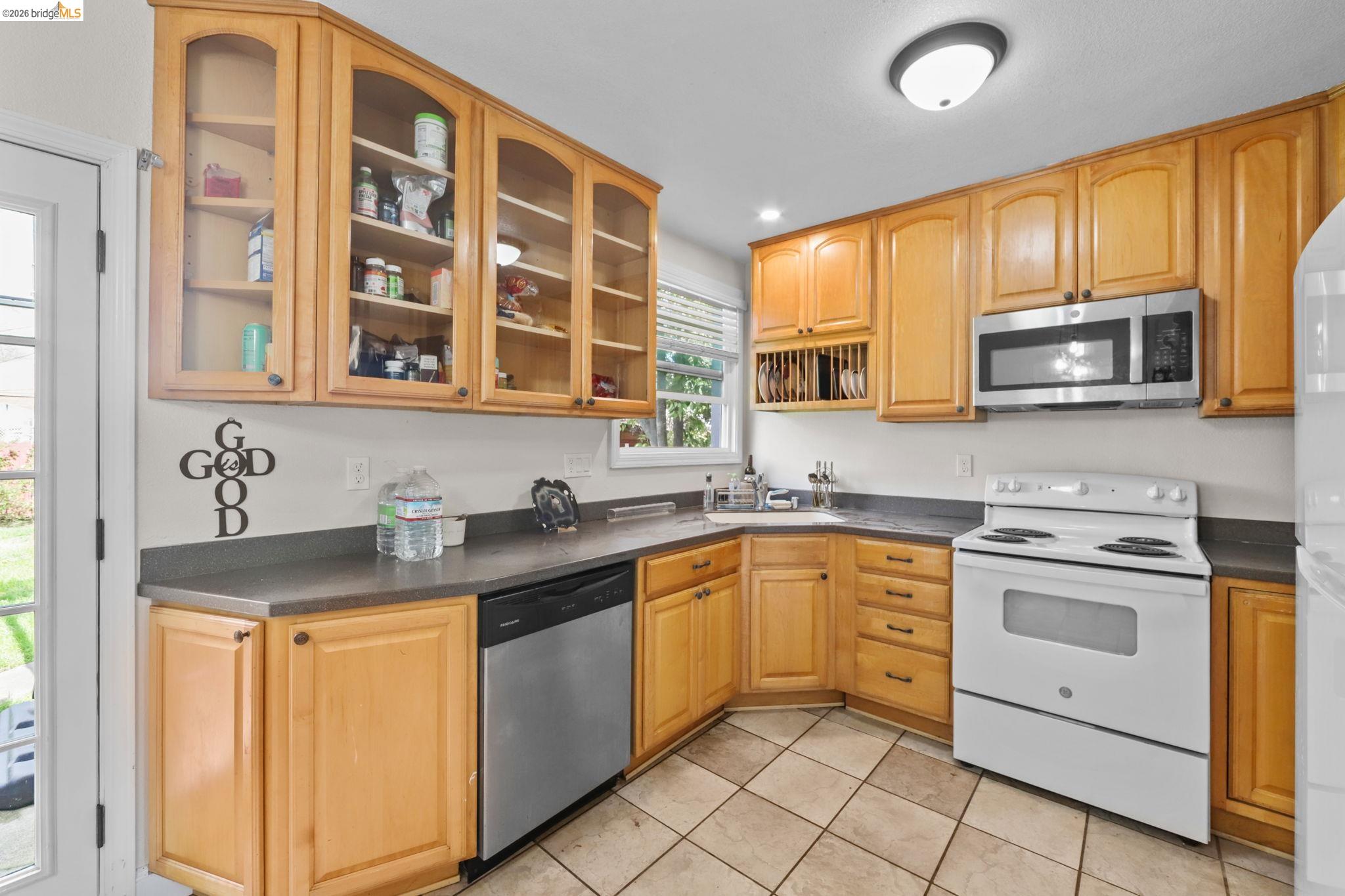 104 Foster Street Vallejo, CA 94591 - Photo 31 of 34 a kitchen with stainless steel appliances granite countertop a sink stove and microwave